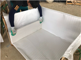 Factory worker preparing wooden crate with foam lining for StaturioVN tiles